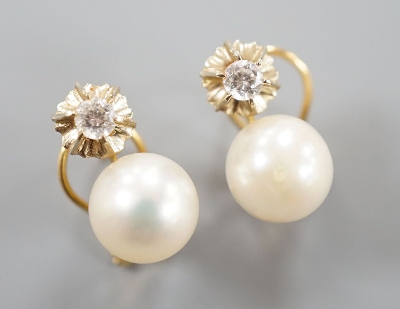 A modern pair of Italian 750 yellow metal, culture pearl and diamond set earrings, 14mm, gross weight 4.2 grams.